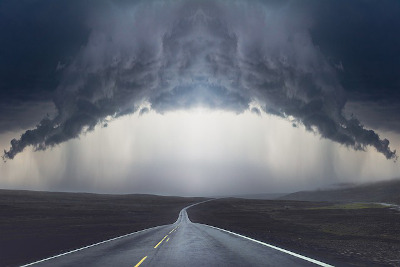 pic of highway beneath spooky overcast skies